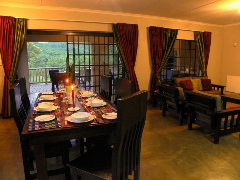 Spacious living area opening to covered veranda with wooden deck